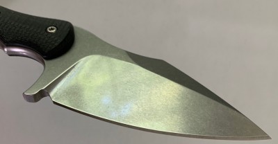 Factory edge is shown here.  Sharp enough to slice a paper, but not sharp enough to split hair.  Note the edge bevel is wider towards the tip of the blade, implying the bevel angle is not quite as uniform along the edge length.