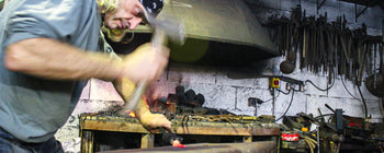 Fred Perrin forging a knife blade.