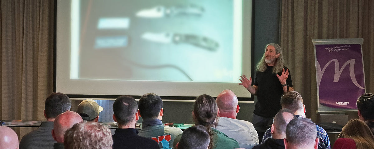 Eric Glesser giving a presentation in front of a crowd.