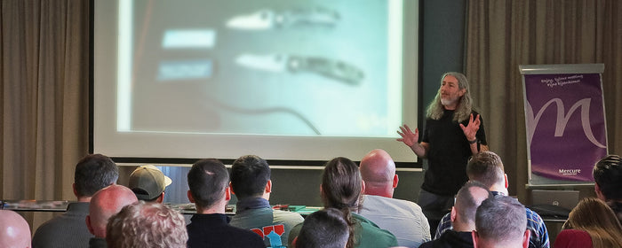 Eric Glesser giving a presentation in front of a crowd.