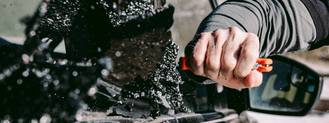 An image of a Spyderco Assist breaking the window of a car in a rescue scenario.