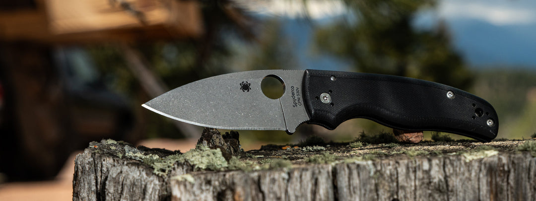 An image of a Spyderco folding knife outdoors - The Shaman.