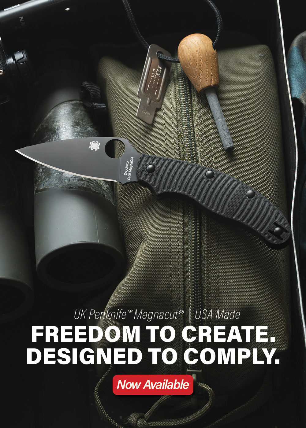 All black UK Penknife laying on outdoor gear.