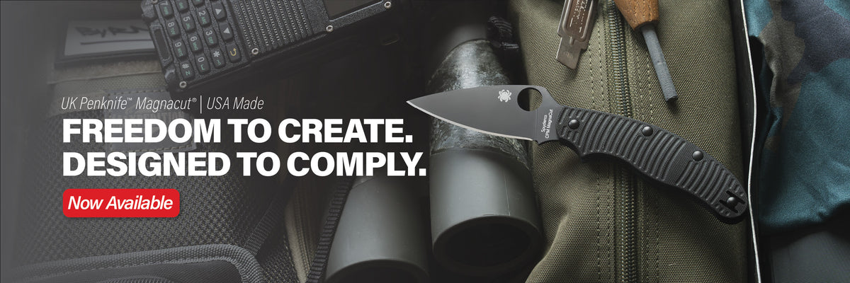 All black UK Penknife laying on outdoor gear.