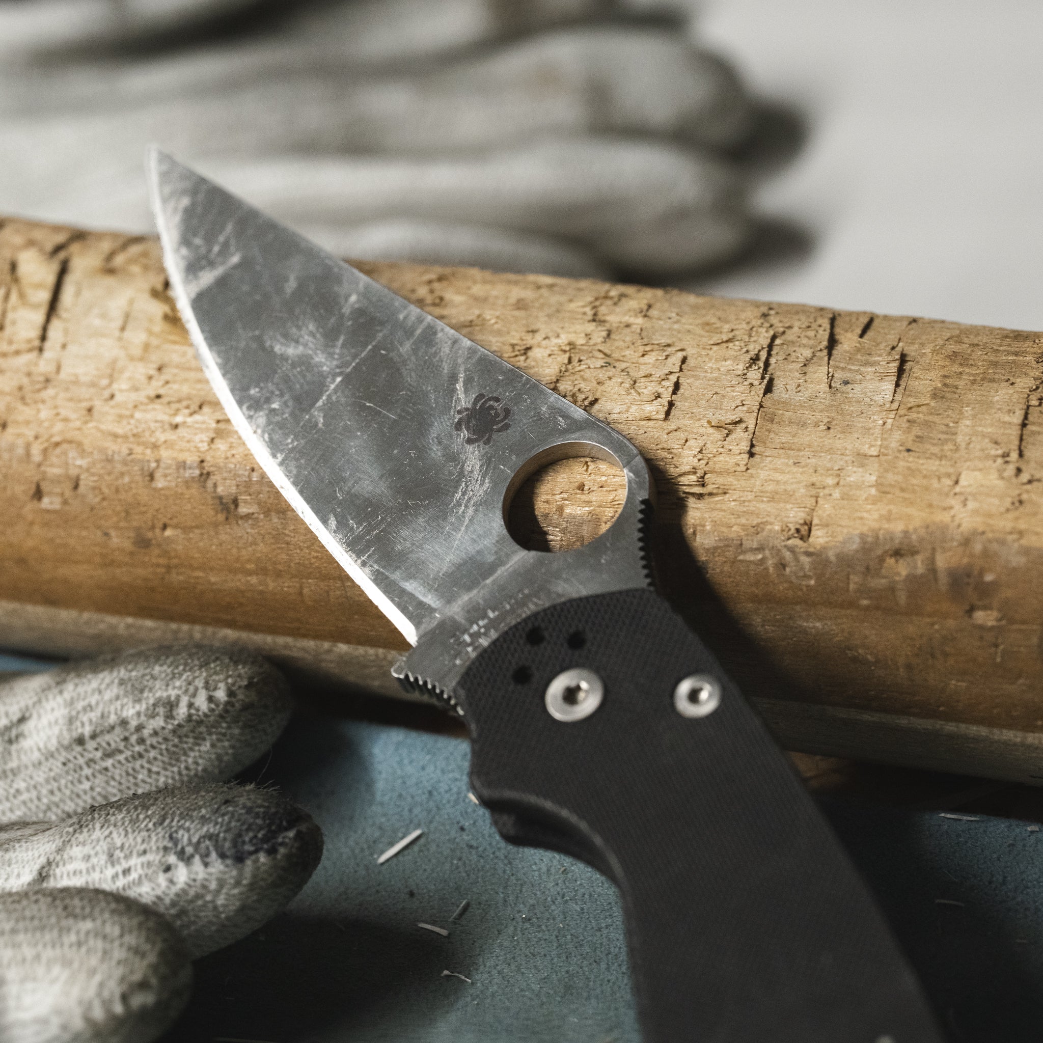 A dirty knife blade on a Whittled wood.