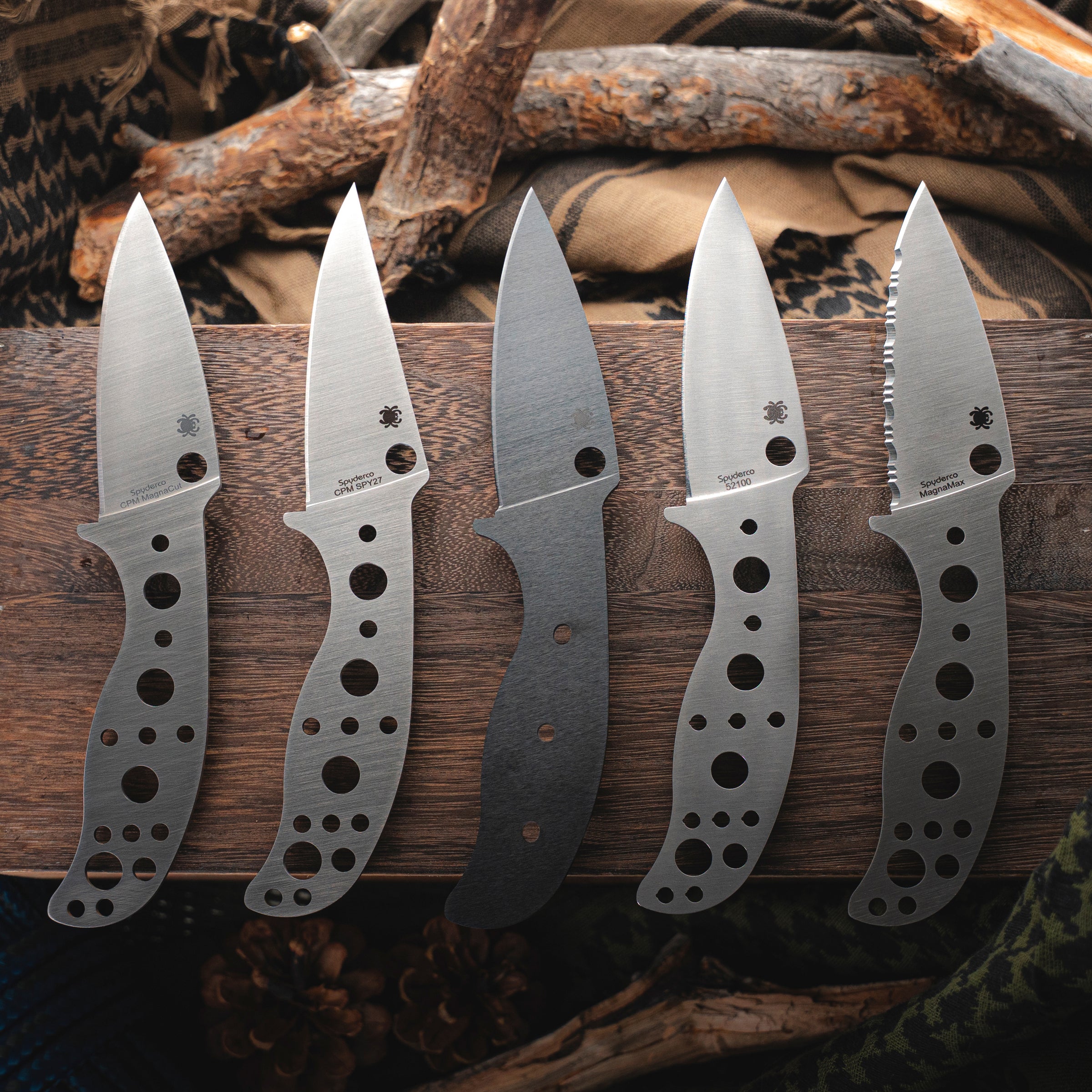 5 Spyderco Mule Team knives on a wooden background.