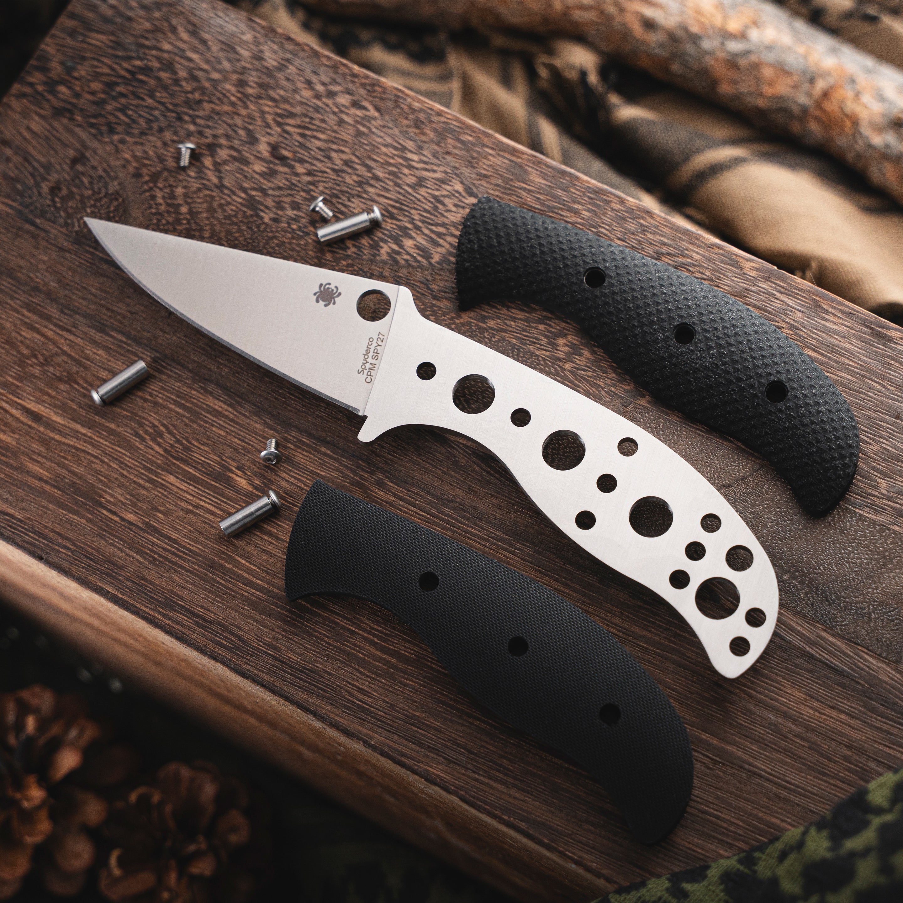 A Mule Team knife and scales sitting on a wood box.